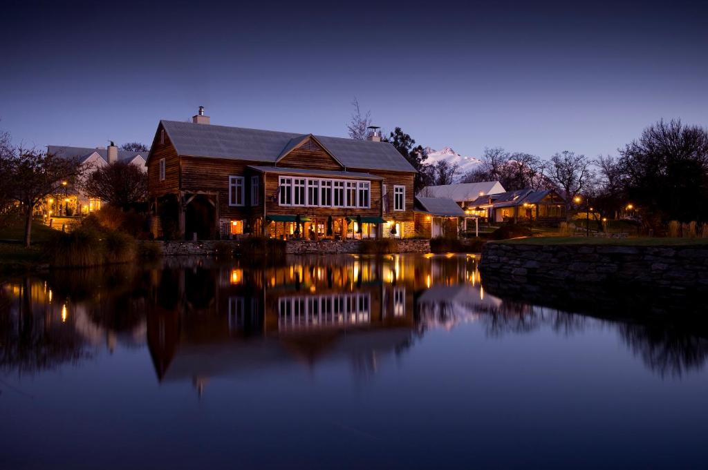 Millbrook Resort at dusk, reflected in the lake with mountains behind